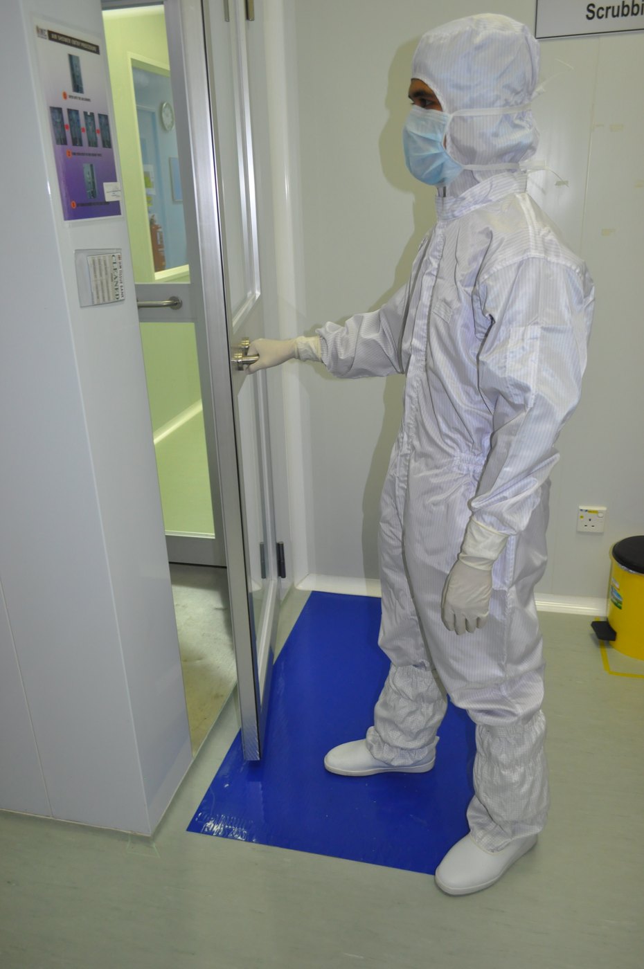 Staff member gowned before entering the air shower